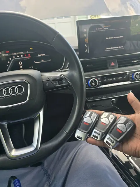 Three new Audi smart keys in front of the steering wheel