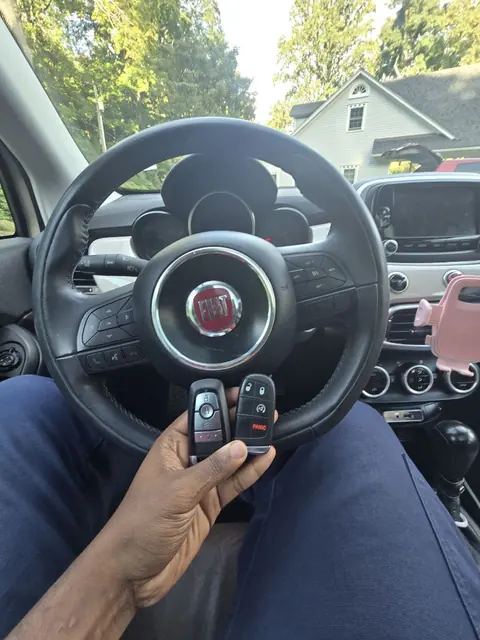Two new smart keys in front of a Fiat steering wheel