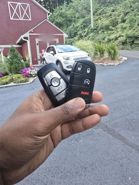 Two new smart key fobs held up outside